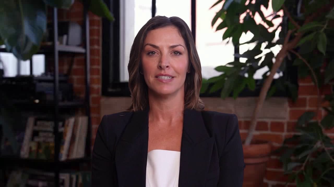 A professional interviewer on a Zoom video call, with the AcedlyAI desktop app overlaid.